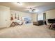 Spacious living room features modern ceiling fan, guitars and a large television at 132 Cornerstone Pl, Woodstock, GA 30188