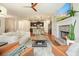 Spacious living room featuring hardwood floors and kitchen in background, fireplace and comfortable seating at 132 Cornerstone Pl, Woodstock, GA 30188
