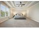 Bright main bedroom features a trey ceiling, a large window, and soft, neutral carpet at 132 Cornerstone Pl, Woodstock, GA 30188