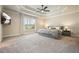 Spacious main bedroom features a trey ceiling, large window with backyard views, and plush carpet at 132 Cornerstone Pl, Woodstock, GA 30188