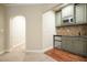 View of mini-bar area with cabinets, sink and small refrigerator at 132 Cornerstone Pl, Woodstock, GA 30188