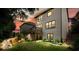 Back of house showcasing a wood deck overlooking a manicured backyard and garden with lovely sunset at 132 Cornerstone Pl, Woodstock, GA 30188