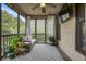 Cozy screened porch with comfortable seating and view of the backyard at 132 Cornerstone Pl, Woodstock, GA 30188