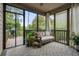 Comfortable screened porch with outdoor seating area with plenty of sunlight at 132 Cornerstone Pl, Woodstock, GA 30188