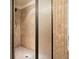 Shower with neutral tile, built-in niche, and glass doors in the bathroom at 132 Cornerstone Pl, Woodstock, GA 30188