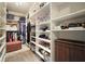 Organized walk-in closet with ample shelving for shoes, hats, handbags, and clothes at 132 Cornerstone Pl, Woodstock, GA 30188