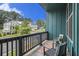 Relaxing balcony with outdoor seating offers a peaceful view of the neighborhood street at 2016 Bixby Byway Se Dr, Atlanta, GA 30317