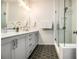 Modern bathroom with double vanity, sleek fixtures, and walk-in shower with glass door at 2016 Bixby Byway Se Dr, Atlanta, GA 30317