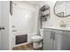 Well-lit bathroom with a combination shower and tub and grey vanity with chrome hardware at 2016 Bixby Byway Se Dr, Atlanta, GA 30317