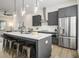 Open kitchen with island seating, stainless appliances, white countertops, and view into the living room at 2016 Bixby Byway Se Dr, Atlanta, GA 30317