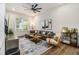 Bright and airy living room featuring hardwood floors, a comfortable sectional, and modern decor at 2016 Bixby Byway Se Dr, Atlanta, GA 30317