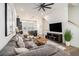 Open-concept living room featuring modern decor, a ceiling fan and seamless flow into the kitchen at 2016 Bixby Byway Se Dr, Atlanta, GA 30317