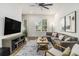 Cozy living room with a large sectional, media console, and view of the outdoor scenery at 2016 Bixby Byway Se Dr, Atlanta, GA 30317