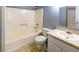 Bathroom featuring a standard white bathtub, toilet, sink and vanity with linoleum flooring at 3396 Misty Harbour Trl, Doraville, GA 30340
