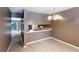 Open dining area with modern lighting fixture, neutral colors, and seamless kitchen access at 3396 Misty Harbour Trl, Doraville, GA 30340