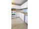 Efficient kitchen showcasing white cabinets and appliances, plenty of storage, and new flooring at 3396 Misty Harbour Trl, Doraville, GA 30340