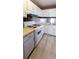 Efficient kitchen featuring white appliances, abundant storage, and new floors at 3396 Misty Harbour Trl, Doraville, GA 30340