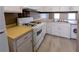 Functional kitchen with white appliances, ample cabinet space, and new flooring at 3396 Misty Harbour Trl, Doraville, GA 30340