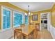 Bright dining area with large windows, a view of nature, a dining table, and a view of the laundry area at 3914 Granger Dr, Atlanta, GA 30341
