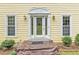 Elegant front entrance featuring a decorative glass door, sidelights, and manicured shrubs enhancing curb appeal at 3914 Granger Dr, Atlanta, GA 30341