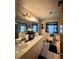 This bathroom features a double sink vanity, a shower with glass doors and several windows for natural light at 791 Bristol Way, Lithonia, GA 30058