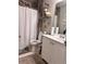 This bathroom features a shower with a shower curtain, a modern single sink vanity, and tasteful decor at 791 Bristol Way, Lithonia, GA 30058