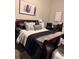Comfortable bedroom features a plush bed with decorative pillows and contemporary artwork at 791 Bristol Way, Lithonia, GA 30058