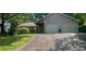 Traditional home with a two-car garage, inviting driveway, and lush green lawn at 791 Bristol Way, Lithonia, GA 30058