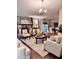 Comfortable living room with stone fireplace and elegant chandelier creating a warm and inviting atmosphere at 791 Bristol Way, Lithonia, GA 30058
