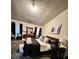 This primary bedroom boasts a stylish design with a textured ceiling, and a cozy seating area at 791 Bristol Way, Lithonia, GA 30058