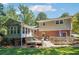 Backyard featuring a two-tiered deck, patio furniture, and a large, grassy lawn at 190 Windflower Trce, Roswell, GA 30075