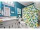 Stylish bathroom with a lemon-themed shower curtain and teal-painted walls at 190 Windflower Trce, Roswell, GA 30075