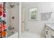 Bright bathroom with updated fixtures and shower-tub combination with colorful shower curtain at 190 Windflower Trce, Roswell, GA 30075