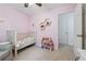 Bedroom features a crib, carpeted floors, and neutral decor at 190 Windflower Trce, Roswell, GA 30075