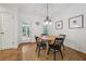 Dining area with a wood table, pendant lighting, round jute rug, and white walls at 190 Windflower Trce, Roswell, GA 30075