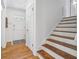 Welcoming entryway featuring hardwood floors, stairs to the upper level, and a front door at 190 Windflower Trce, Roswell, GA 30075