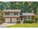 Charming two-story home with a brick and siding exterior, attached two-car garage, and landscaped front yard at 190 Windflower Trce, Roswell, GA 30075