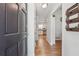 Hallway with hardwood floors, a view into the kitchen, and stylish details at 190 Windflower Trce, Roswell, GA 30075