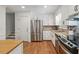 Bright kitchen with stainless steel appliances, granite countertops, and white cabinets at 190 Windflower Trce, Roswell, GA 30075