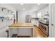 Bright kitchen featuring stainless steel appliances, granite countertops, and white cabinets at 190 Windflower Trce, Roswell, GA 30075