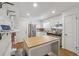 Kitchen featuring stainless steel appliances, white cabinets, and an island butcher block countertop at 190 Windflower Trce, Roswell, GA 30075