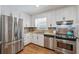 Bright kitchen with stainless steel appliances, beautiful countertops, and tiled backsplash at 190 Windflower Trce, Roswell, GA 30075