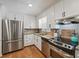 Kitchen featuring stainless steel appliances, granite countertops, and white cabinets at 190 Windflower Trce, Roswell, GA 30075