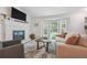 Bright living room featuring a fireplace, bay window, neutral walls and decor, and hardwood floors at 190 Windflower Trce, Roswell, GA 30075