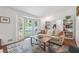Cozy living room featuring a large bay window, comfortable sofa, and built-in bookshelves at 190 Windflower Trce, Roswell, GA 30075