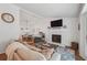 Open-concept living room with a fireplace, dining area, and hardwood floors for seamless entertaining at 190 Windflower Trce, Roswell, GA 30075