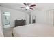 Bright bedroom with a ceiling fan, dresser, closet, and an ensuite bathroom at 190 Windflower Trce, Roswell, GA 30075