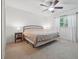 Spacious bedroom with a ceiling fan, neutral carpet, and a large window for natural light at 190 Windflower Trce, Roswell, GA 30075
