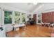Bright sunroom featuring hardwood floors, lots of natural light and an exposed brick wall at 190 Windflower Trce, Roswell, GA 30075
