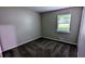 Well-lit bedroom includes a window view, electrical outlets, and clean, neutral paint at 3900 Ferncliff Rd, Snellville, GA 30039